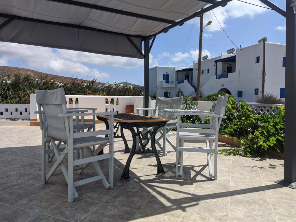 a table and chairs under an umbrella on a patio at Chrysiis House 1 in Maltezana