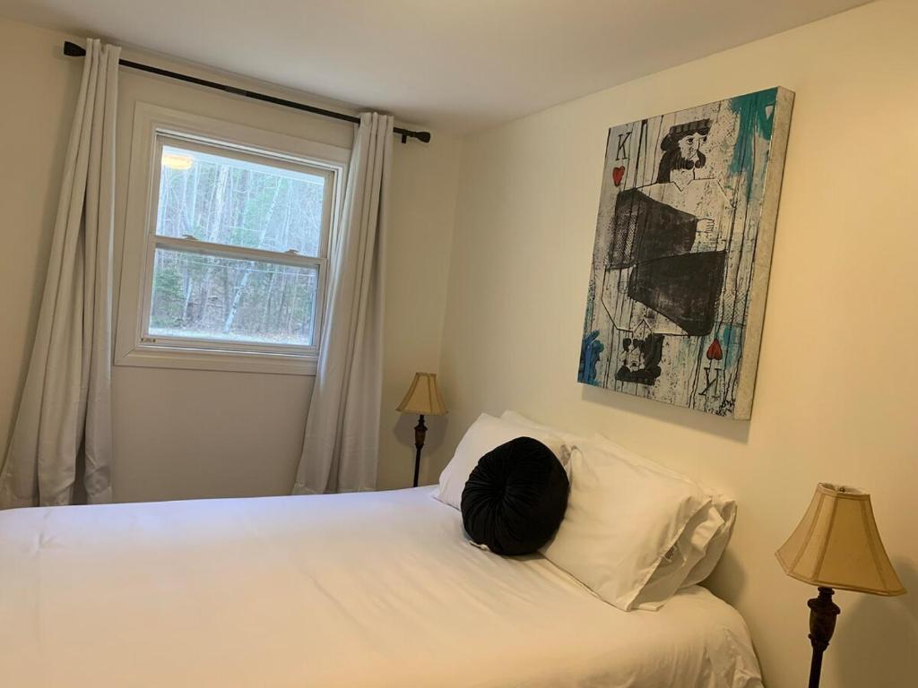 a bedroom with a white bed and a window at 2 bedrooms house in Coldbrooke in Coldbrook