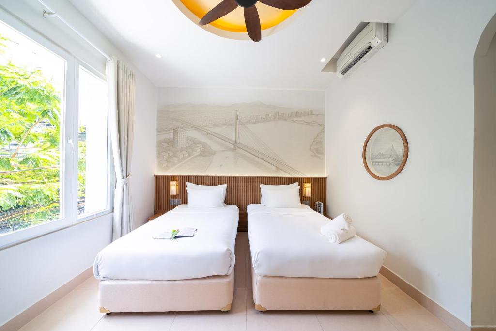 Giường trong phòng chung tại Sujet Residence Da Nang by Haviland