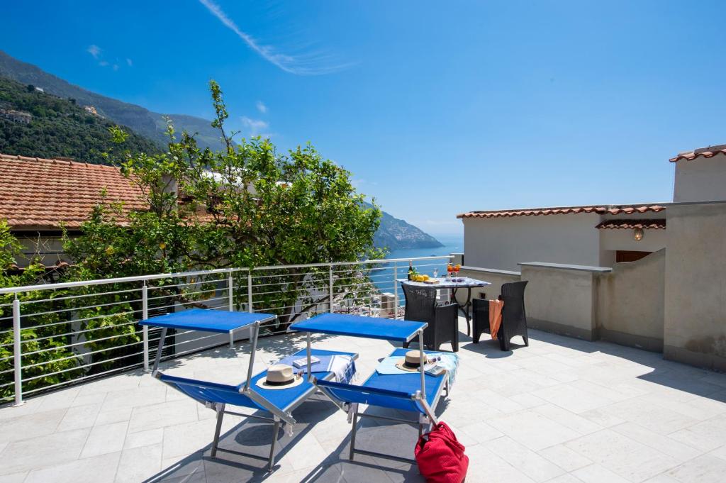 two chairs and a table on a balcony with a view at La Casa di Bruno in Positano