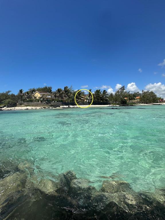 a view of a beach with a wheel in the water at Palmar Bay - Beachside Villa in Palmar