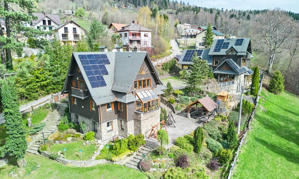 an aerial view of a house with solar panels on its roof at Willa Widok in Szczyrk