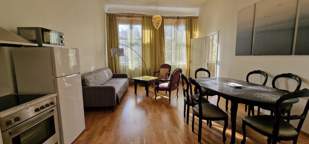 a kitchen and living room with a table and a couch at Old Town Tallinn Luxury Residence in Tallinn