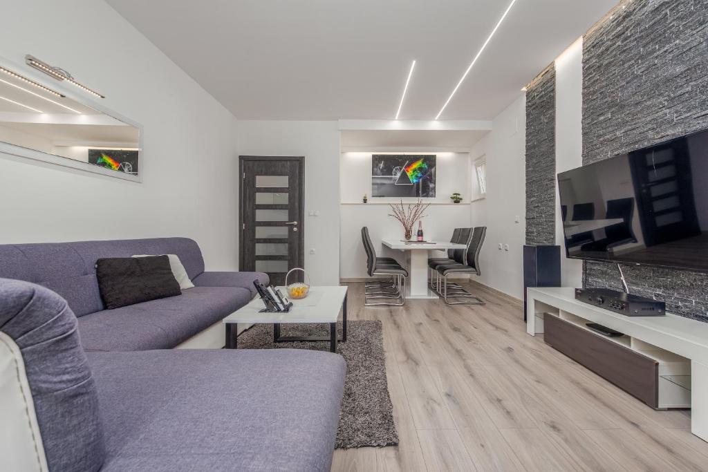 a living room with a couch and a tv at Floyd in Bibinje