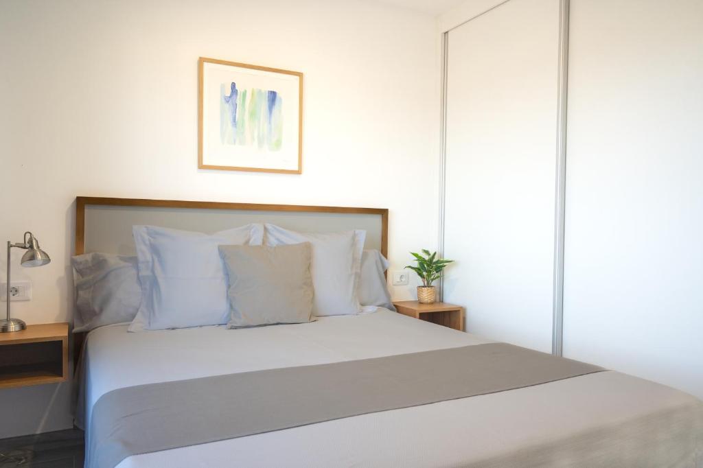 a bedroom with a large white bed with white pillows at ABLANCAS - La Restinga in La Restinga