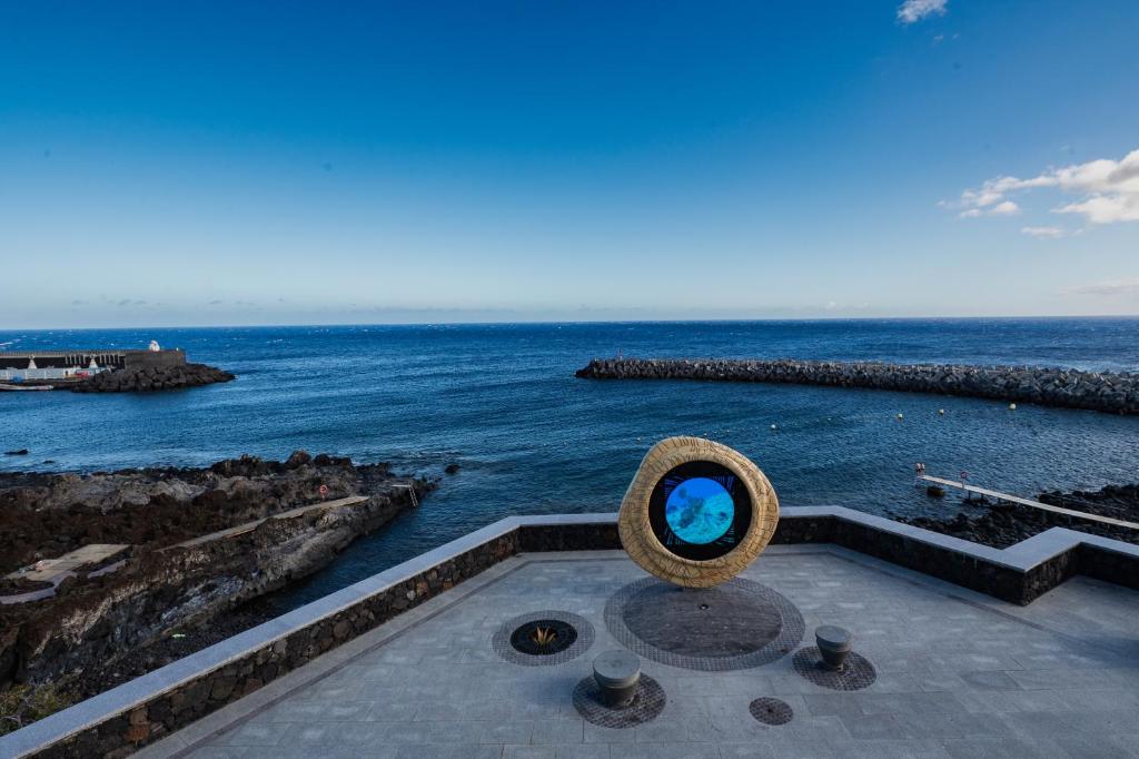 a view of the ocean with a sculpture of a blue ball at ABLANCAS - La Restinga in La Restinga