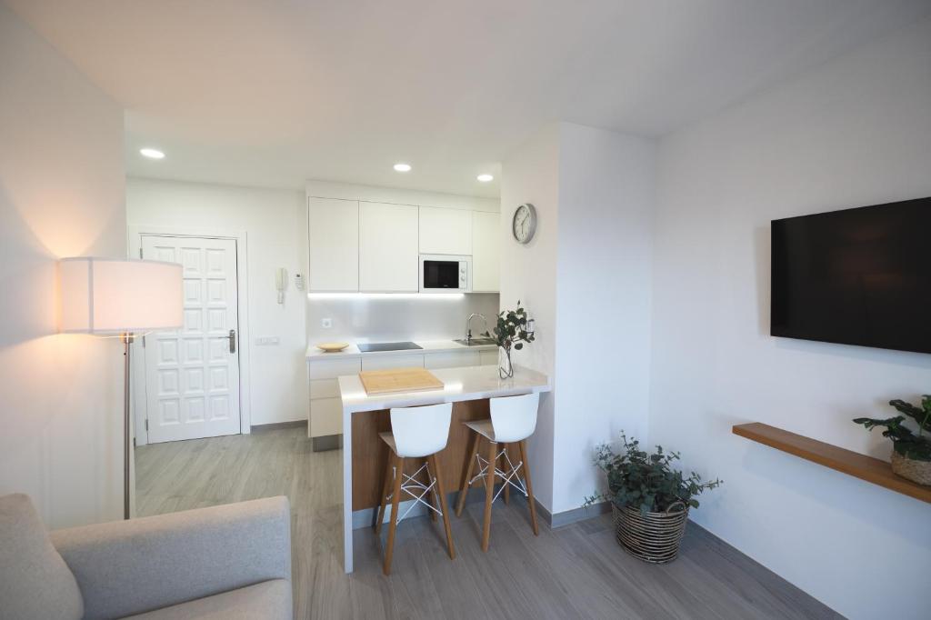 a kitchen and living room with a table and chairs at ABLANCAS - La Restinga in La Restinga