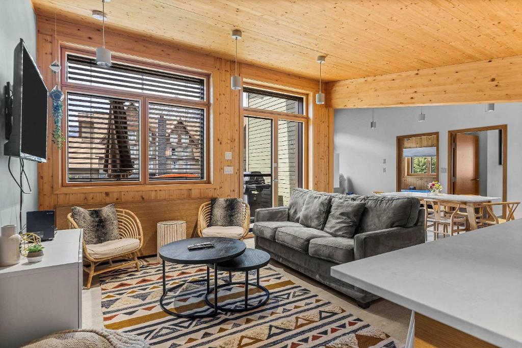 a living room with a couch and a table at Alps #201- LEED Gold Certified & Dog Friendly in Canmore