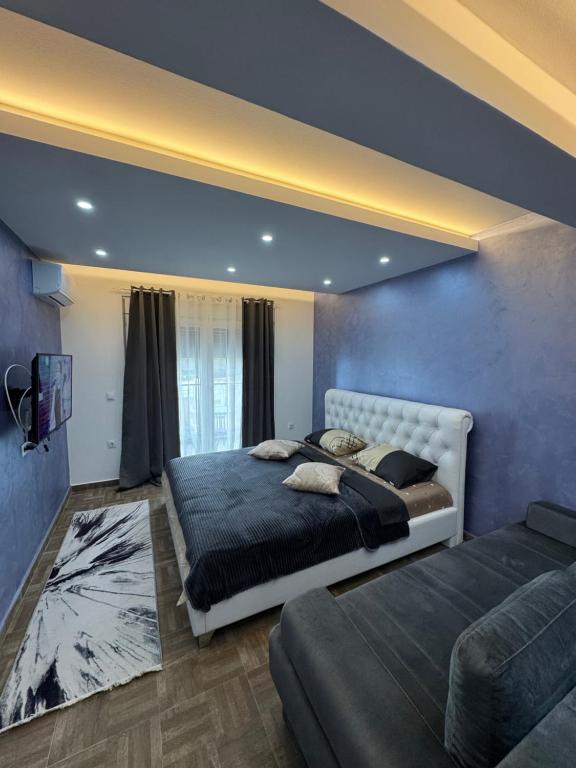 乌尔齐尼Stan Pinjes - Ulcinj的一间卧室，里面有两张床和一台电视