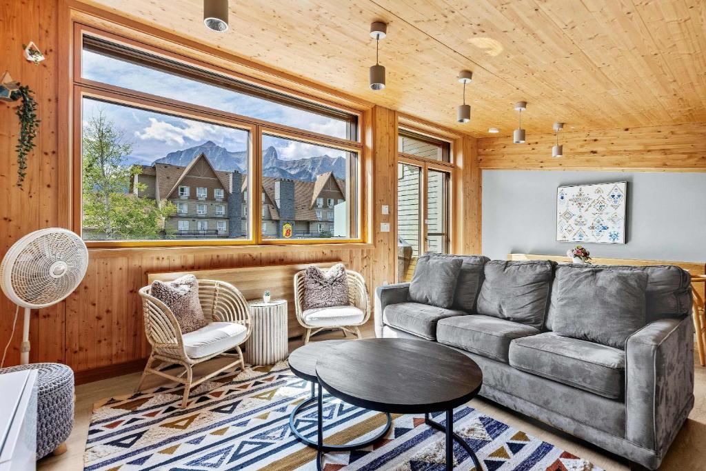 a living room with a couch and chairs and a table at Dolomites #203 - LEED Gold Certified in Canmore