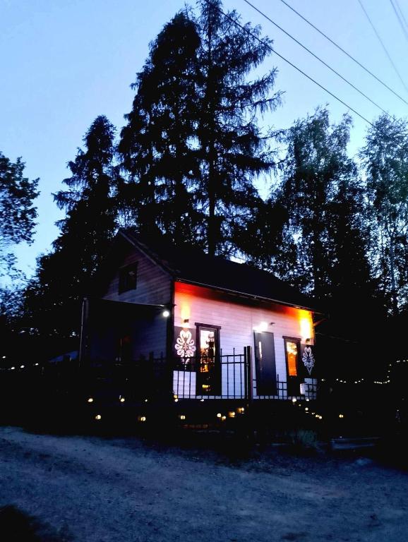a small house lit up at night with lights at Domek na grapie in Gilowice
