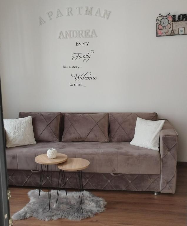 a living room with a couch and a table at APARTMAN ANDREA in Leskovac