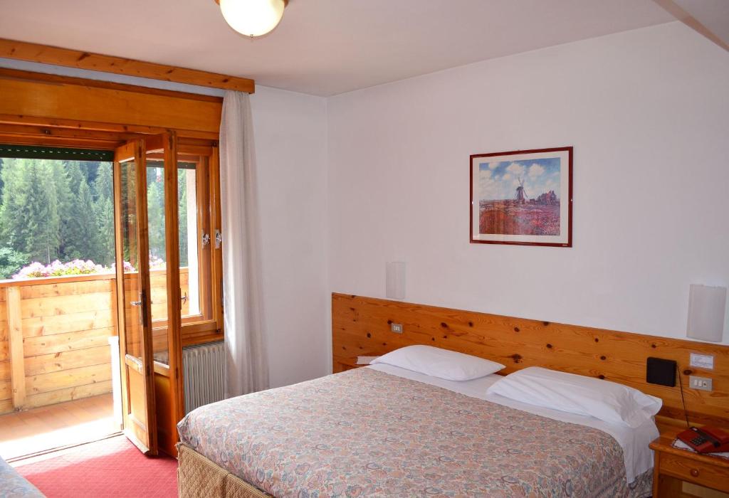 Postel nebo postele na pokoji v ubytování Hotel Coldai