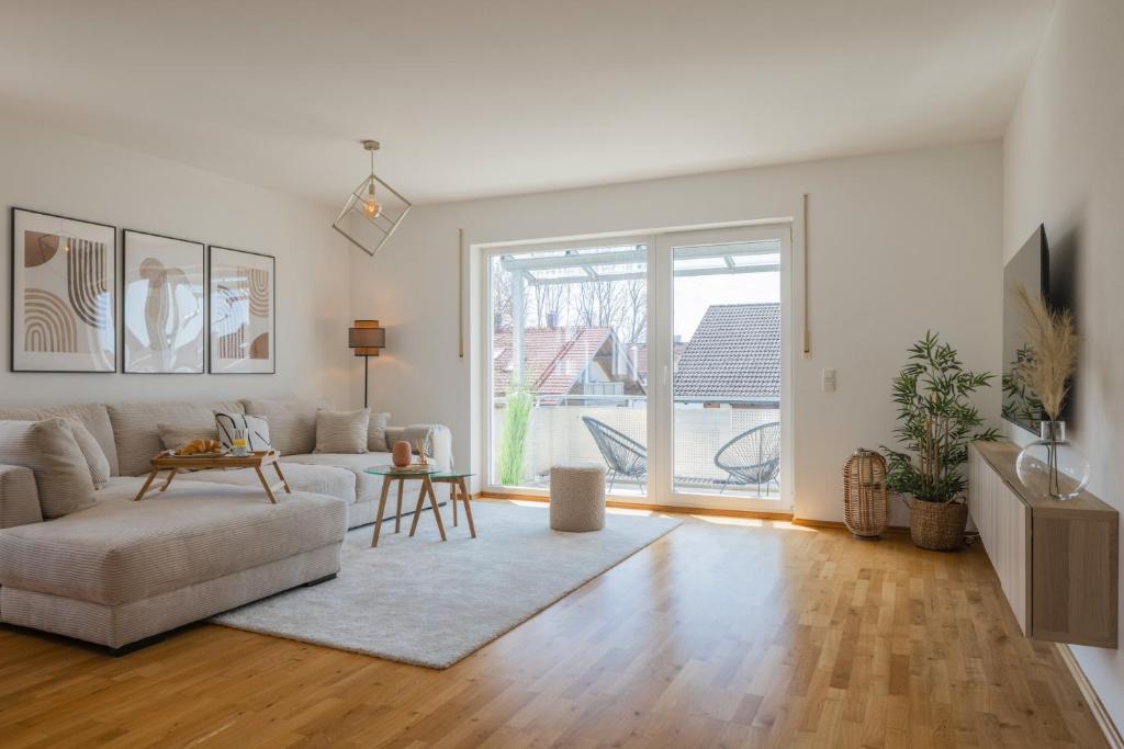 a living room with a couch and a table at Step Apartments - Large, Luxurious and Central in Bad Aibling