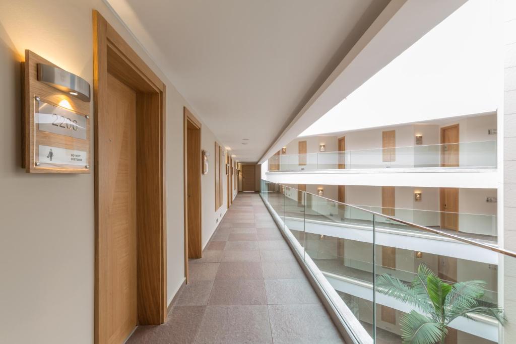 an empty hallway in a building with glass floors at Boyalik Beach Hotel & Spa Cesme in Çeşme