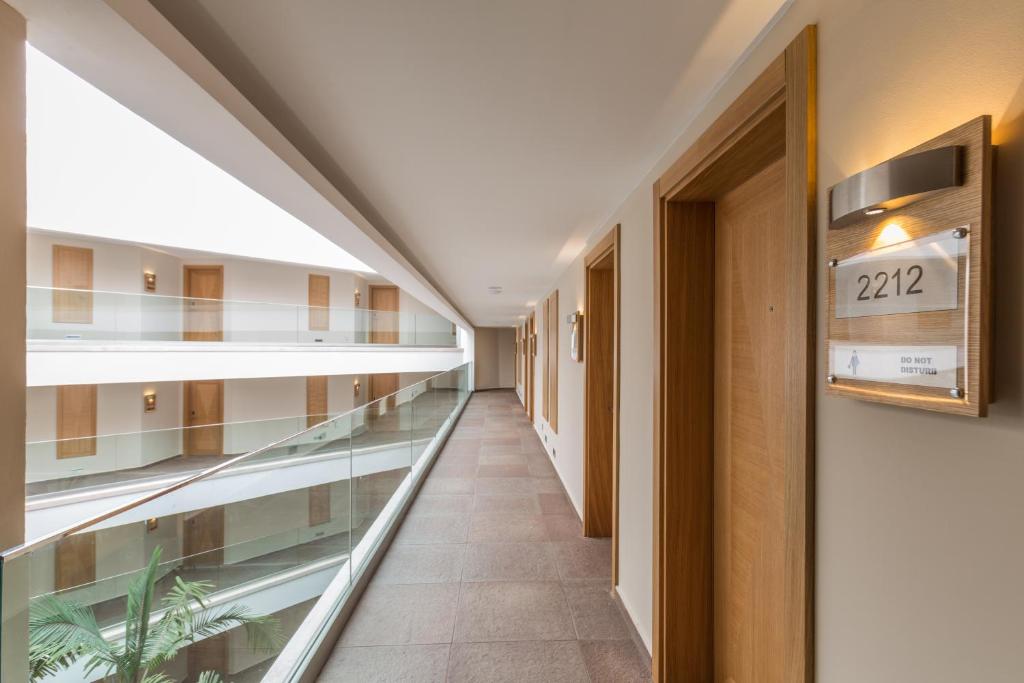 an empty corridor in a hospital with a glass walkway at Boyalik Beach Hotel & Spa Cesme in Çeşme