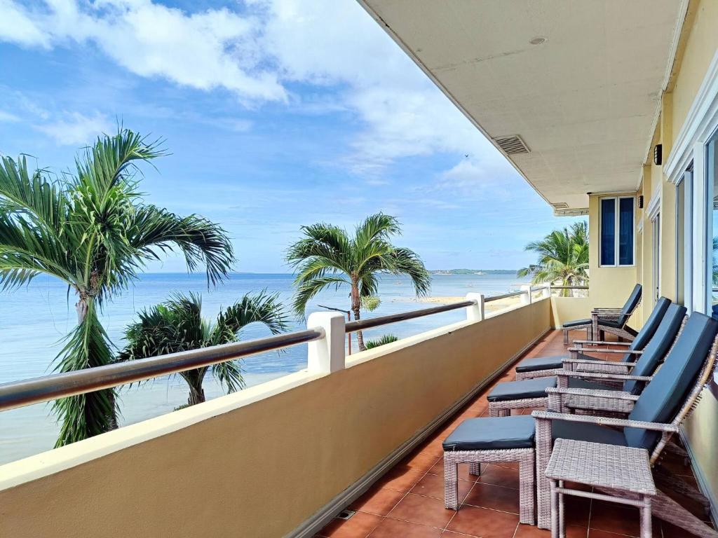 a balcony with chairs and a view of the ocean at Medellin Beachvilla 5BR | Billiard | Fiber 100Mbps in Medellin