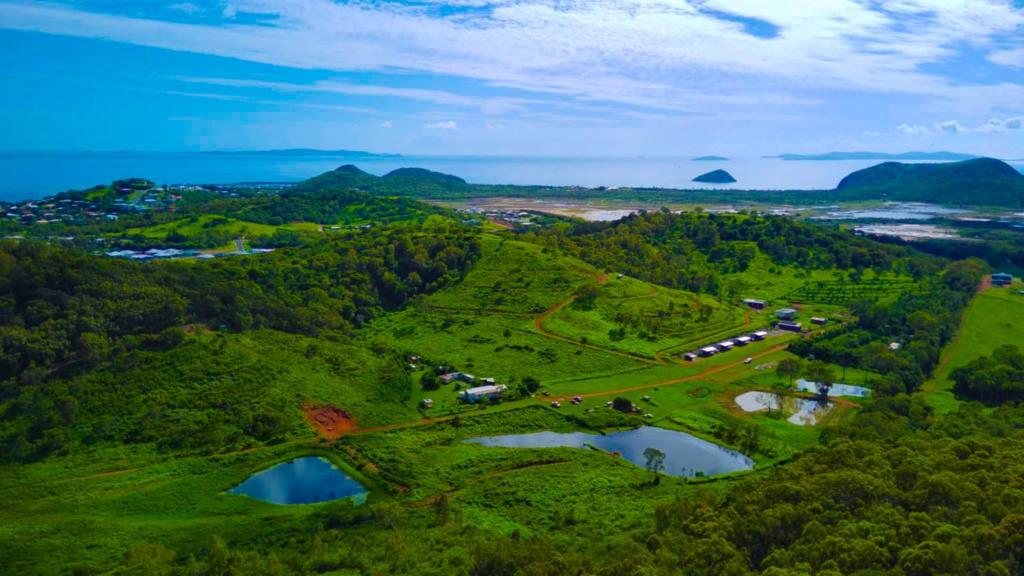 an aerial view of a park with trees and water at High Valley Dawn Permaculture Farm in Yeppoon