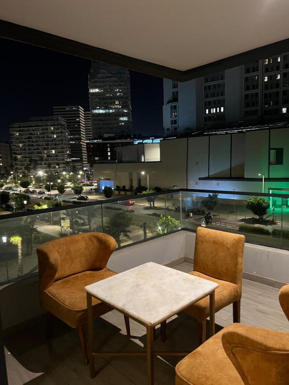 a room with a table and chairs and a view of a city at Casablanca Finance City 33 Tower in Casablanca