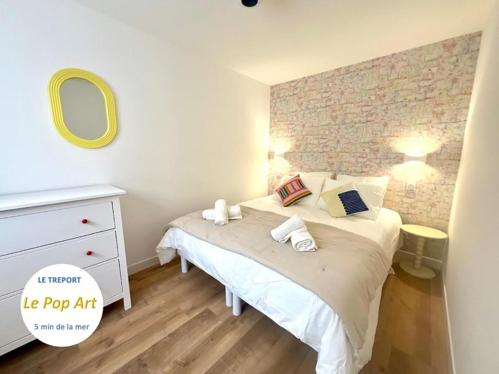 une petite chambre avec un lit et un miroir dans l'établissement Appartement le Pop Art, à deux pas du Port, au Tréport