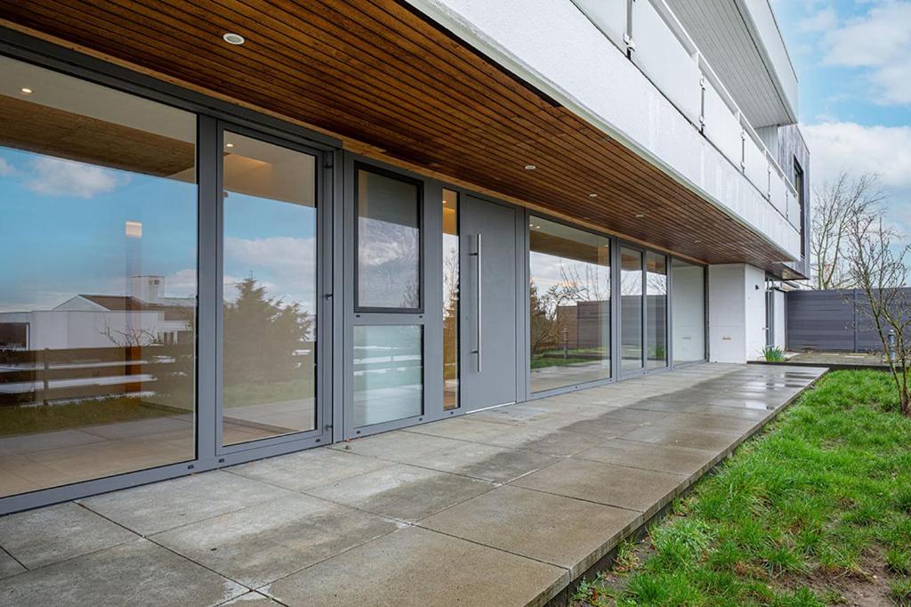 a building with large glass doors on the side of it at Moderne Ferienwohnung in Bergisch Gladbach in Bergisch Gladbach