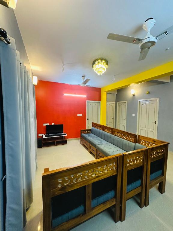 a court room with a bench and a tv at Mj villa in Chennai