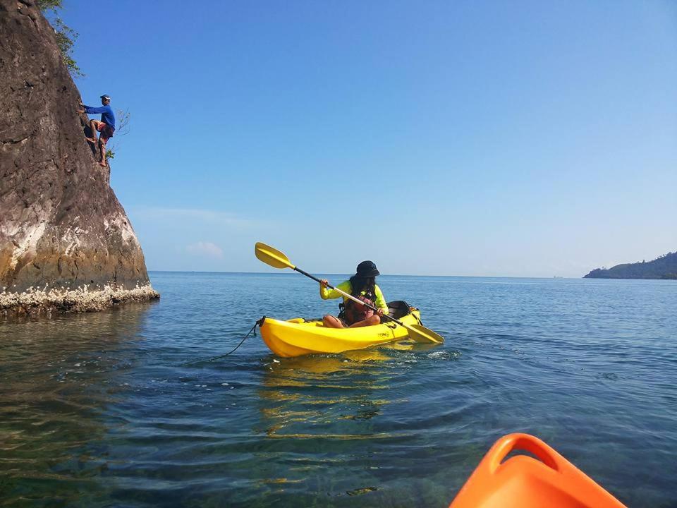 a person in a yellow kayak in the water at Sumatra Ecolodge in Sungaipisang
