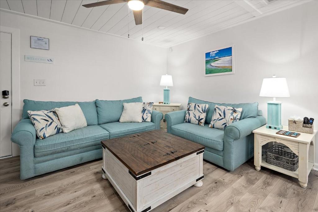 a living room with two blue couches and a table at Ocean Whisperers, 5 min Walk to Boardwalk & Beach, Just Renovated 2025 in Ocean City