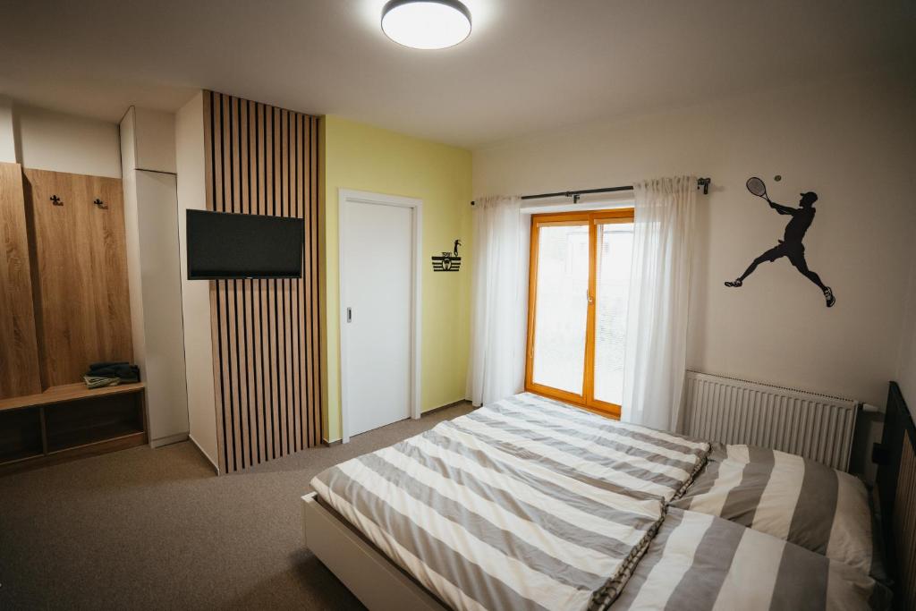 Postel nebo postele na pokoji v ubytování Penzion Tsport