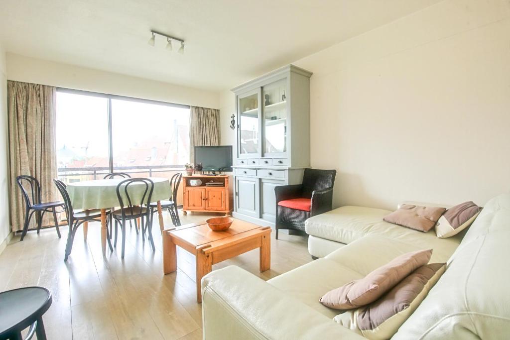 a living room with a couch and a table at Hoge 0410 in Koksijde