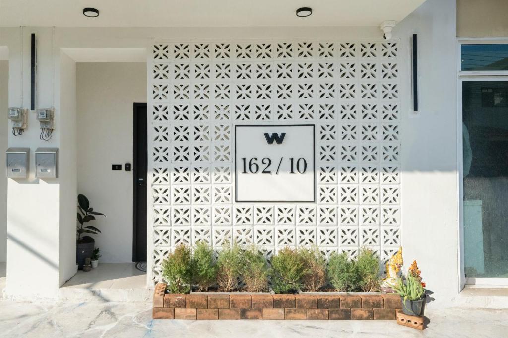 a white wall with a white geometric pattern at Wink Central 9 Patong Beach Phuket in Patong Beach