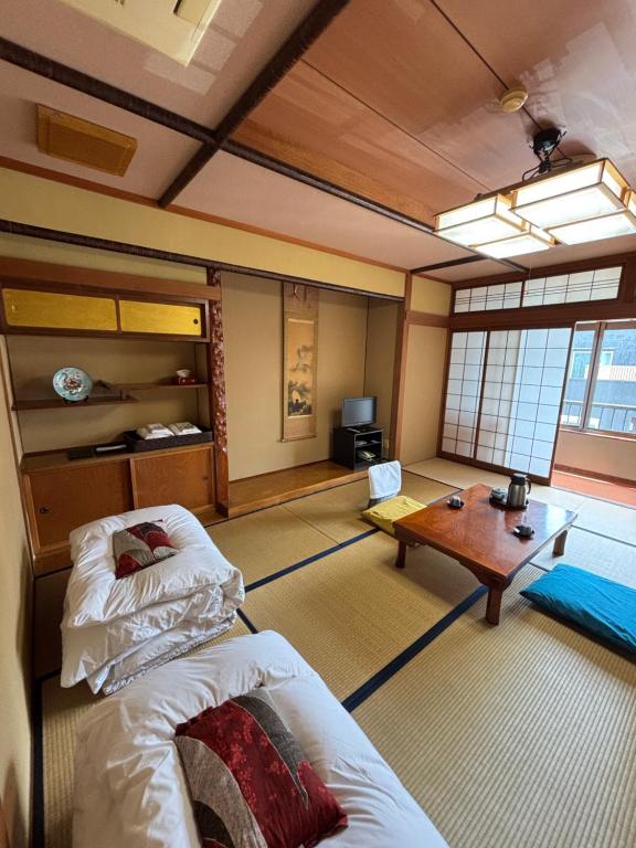 Postel nebo postele na pokoji v ubytování 川端屋　kawabataya