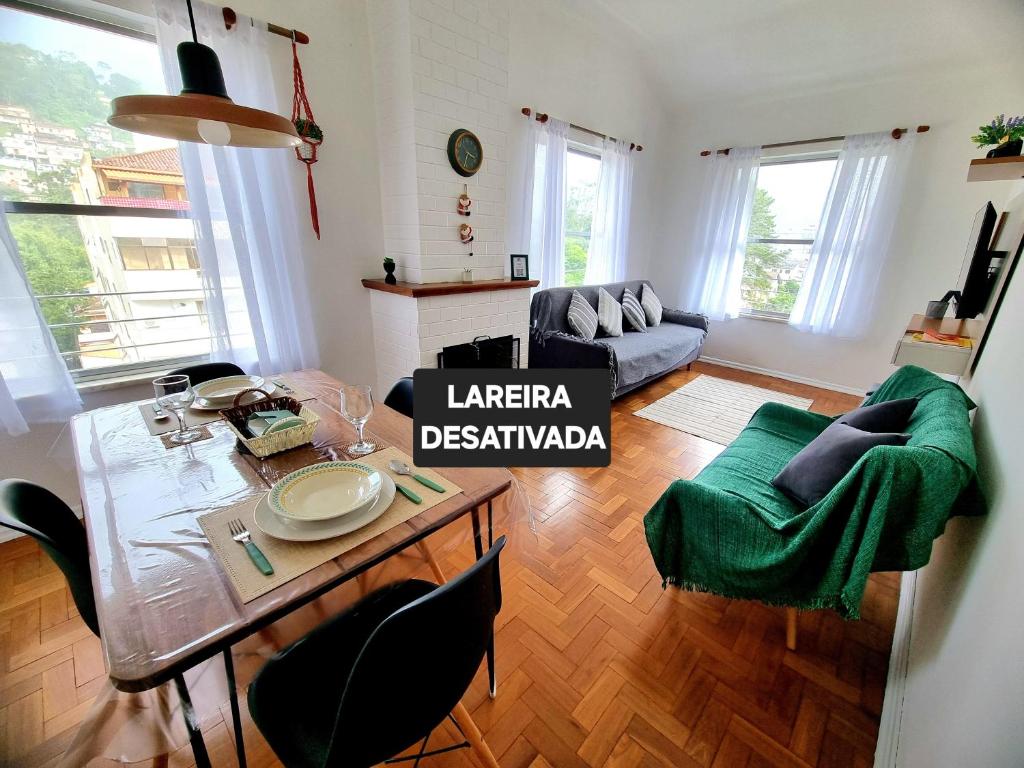 a living room with a table and a couch at Apto 539 Teresópolis in Teresópolis