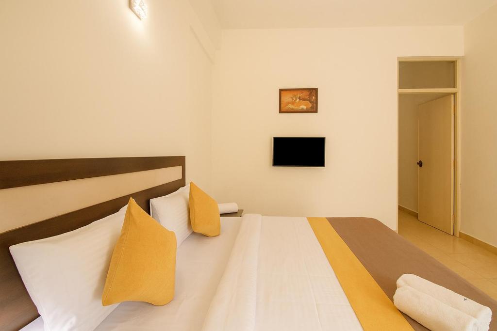 Postel nebo postele na pokoji v ubytování XRP Candolim Holidays