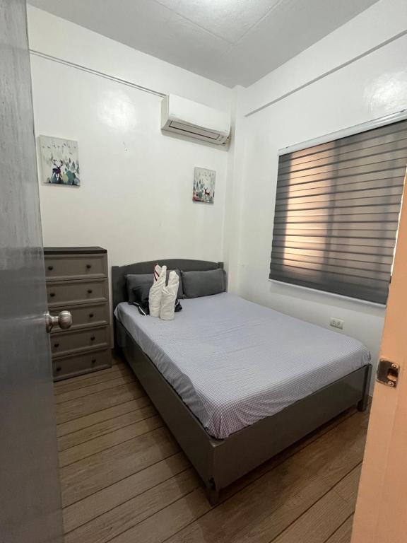 a small bedroom with a bed and a window at San Jose del monte Bulacan gumaok with aircon unit 1 in Mangangpico
