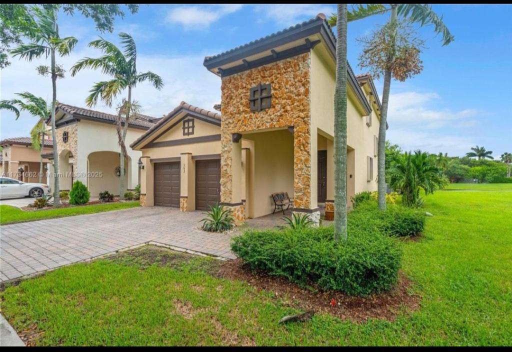 a house with a car parked in front of it at Aloha in Homestead