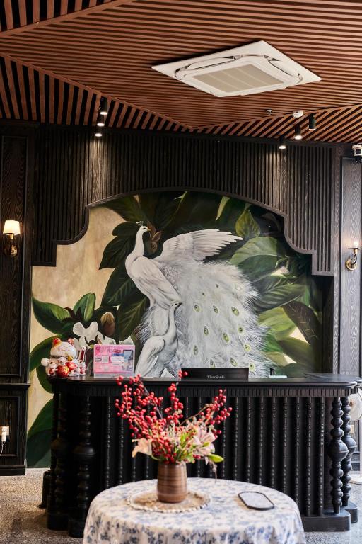 a wall with a painting of a bird on it at The Eden Cat Ba in Cat Ba