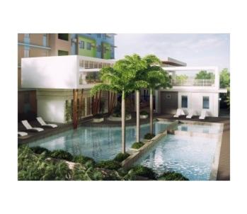 a swimming pool in front of a building at Gales Urban Haven in Iloilo City