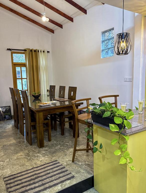 a dining room with a wooden table and chairs at Aloe Serene in Negombo