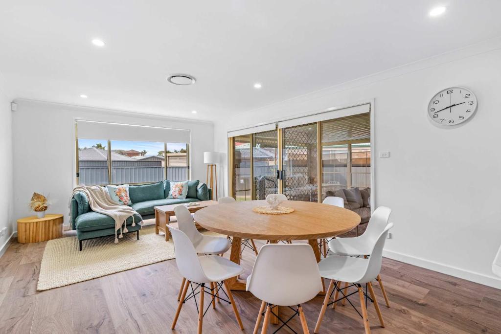 a living room with a table and chairs at Caves Beach House by Coast Hosting in Caves Beach