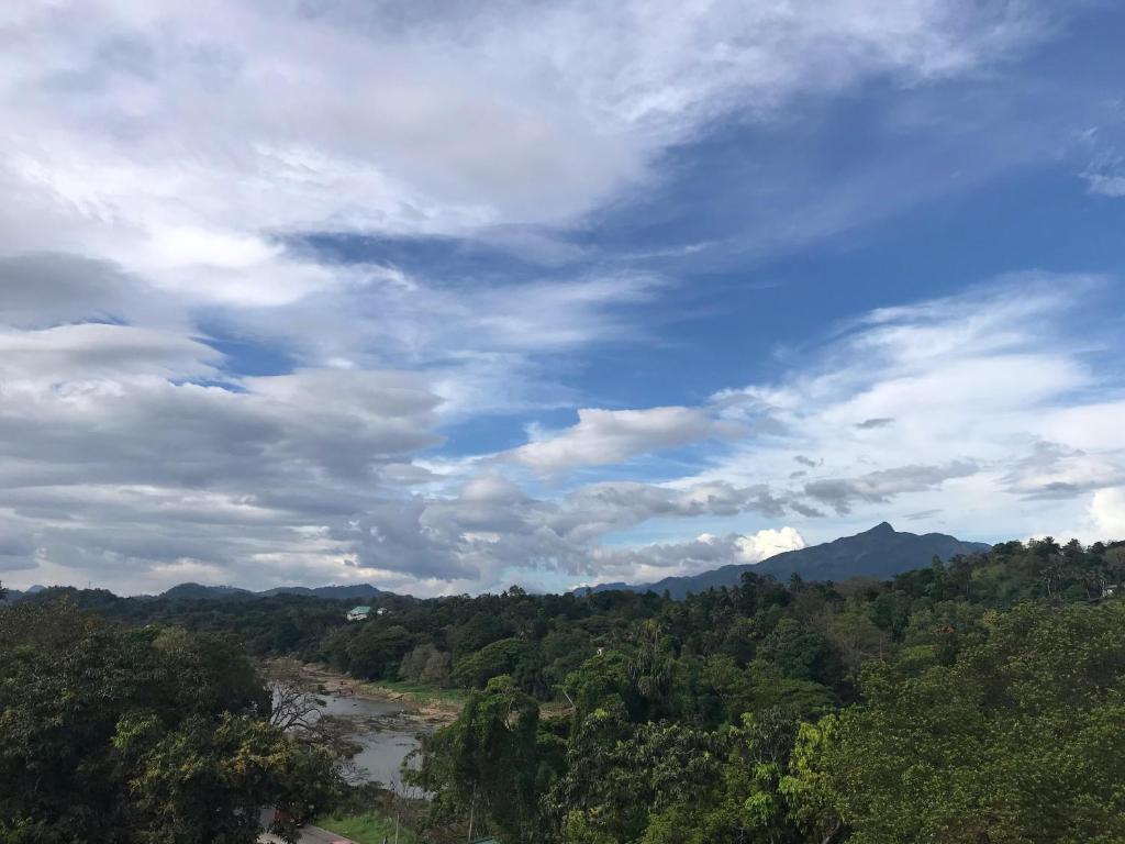 a view of a river and a cloudy sky at Riverside Bliss in Kandy