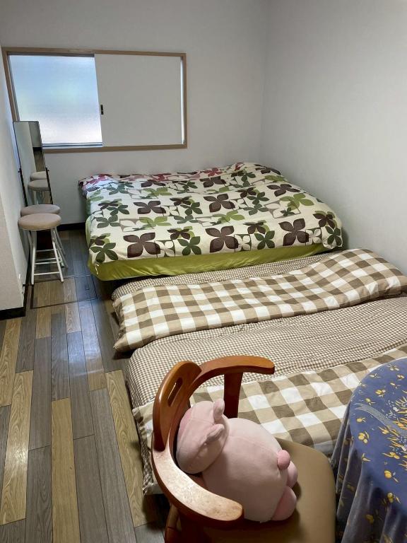 Postel nebo postele na pokoji v ubytování 西軽井沢小木屋