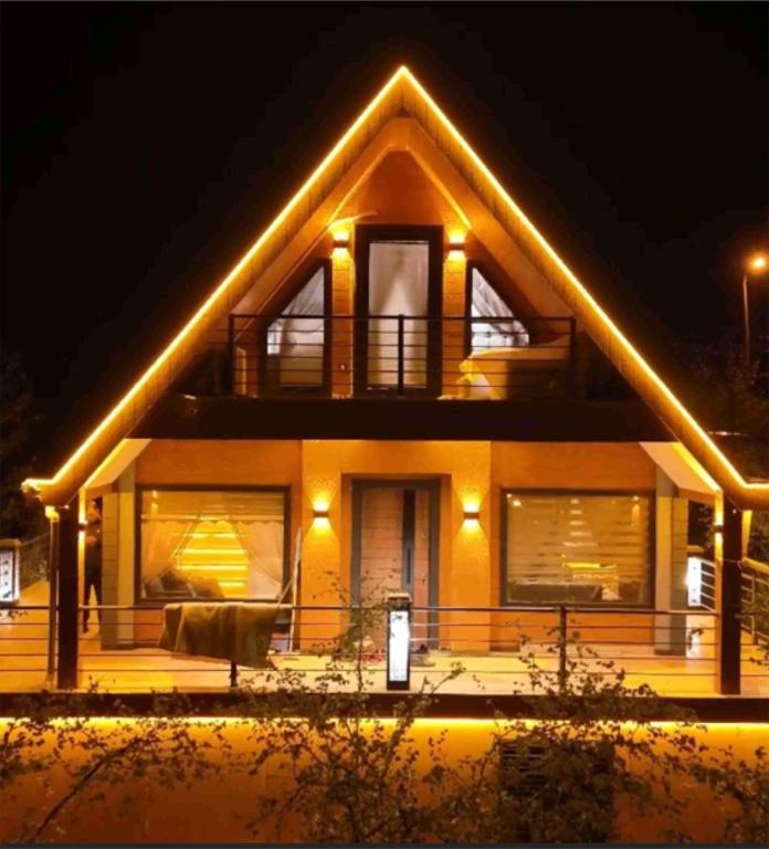 a house with lights on the front at night at BİTEK BUNGALOV in Trabzon
