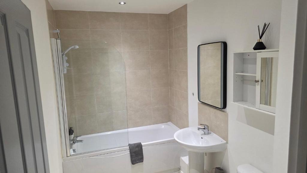 y baño con lavabo, bañera y aseo. en 4 Bedroom Home Tameside Greater Manchester Sleeps 8, en Mánchester
