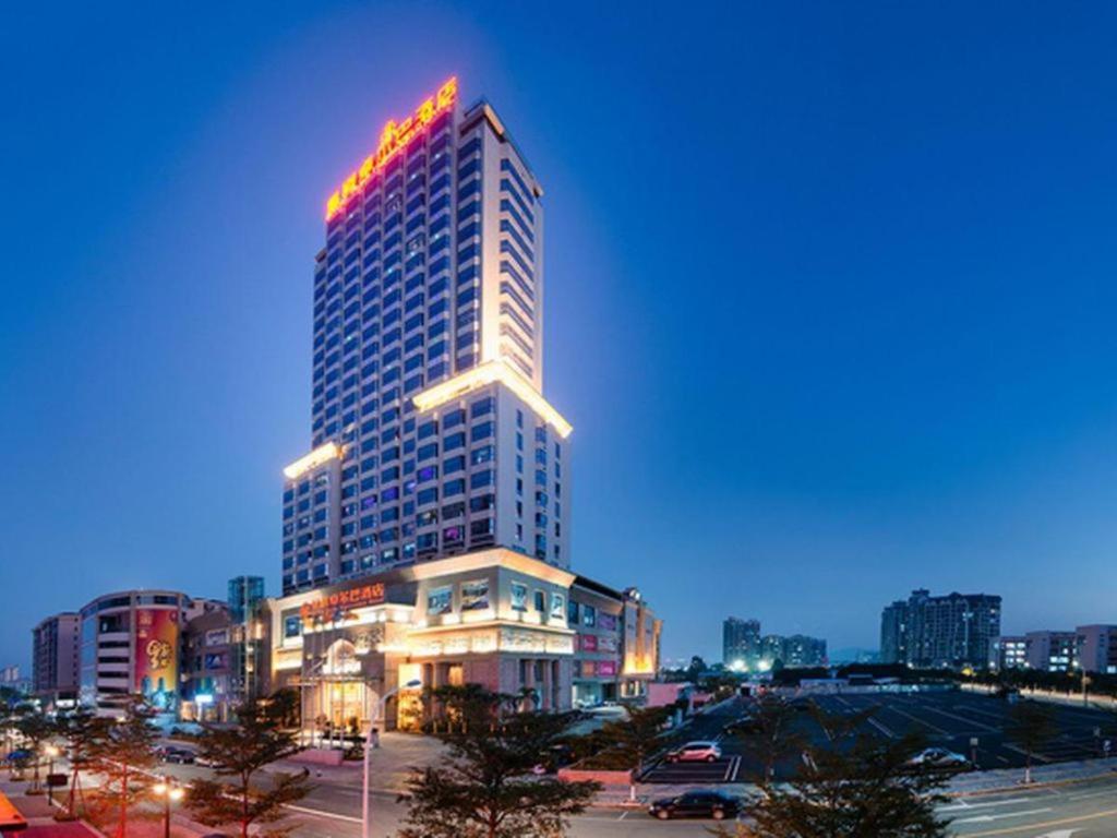 a tall building with a sign on the top of it at Royal Duke Cherrabah Hotel Zhongshan in Yagang