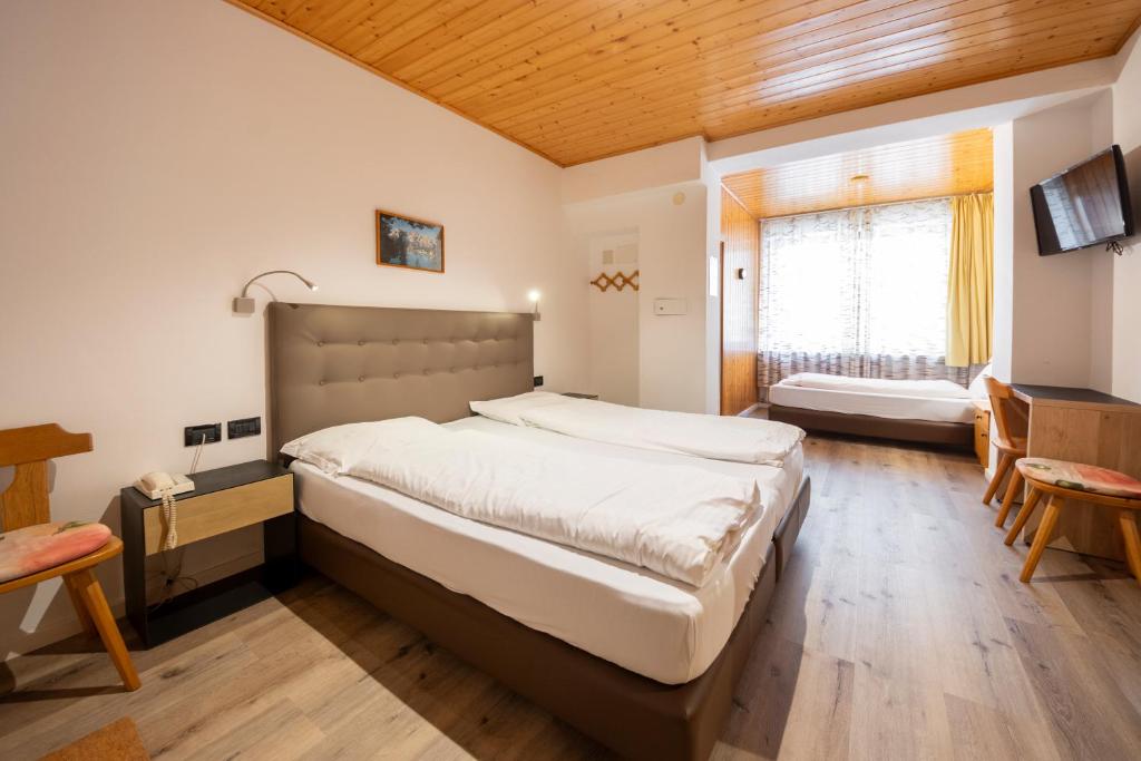 Postel nebo postele na pokoji v ubytování Hotel Oswald