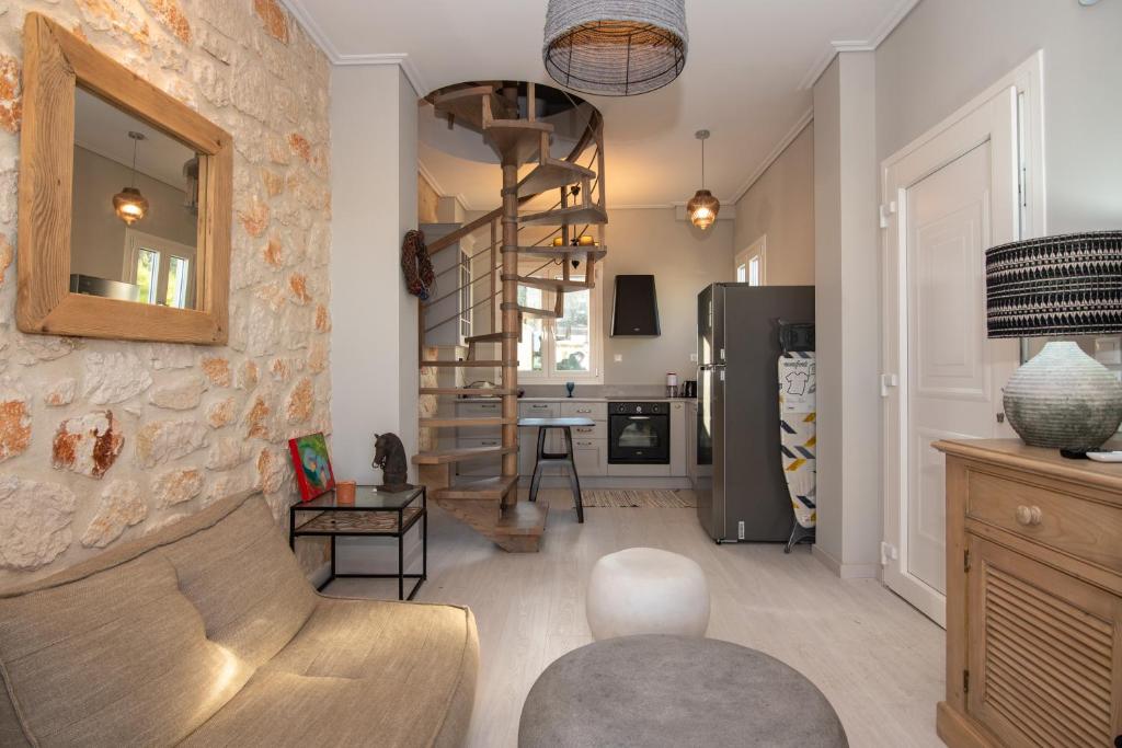 a living room with a stone wall and a spiral staircase at ZANTE STARLET - Chic Hideaway with Pool & Comfort in Lagópodhon