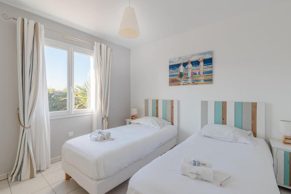 Posteľ alebo postele v izbe v ubytovaní Maison proche de la plage