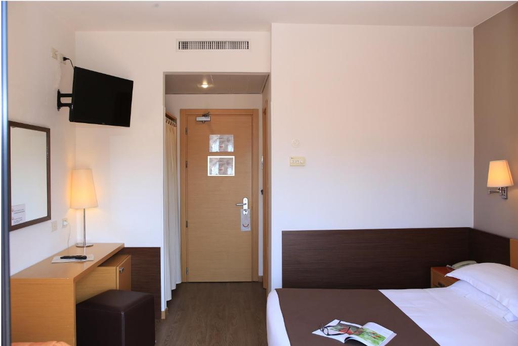 Postel nebo postele na pokoji v ubytování Hotel Sisto V