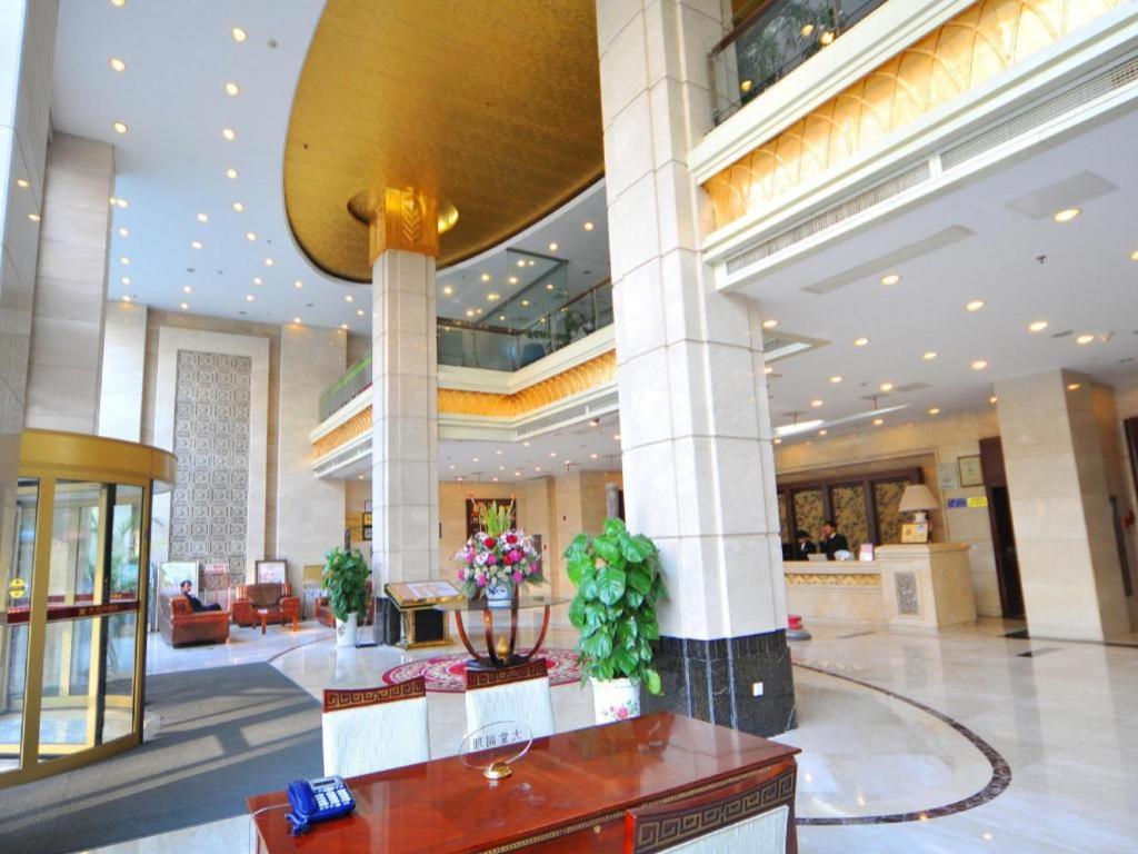 a lobby of a hotel with a large building at Kunshan Yuxing Hotel in Kunshan